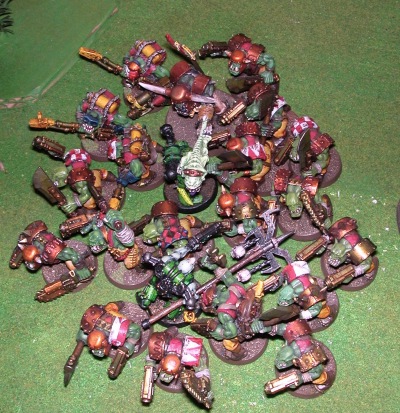 Two plague marines surrounded by Orks