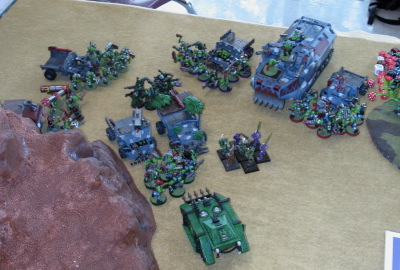 Lee's orks surround my lone plague marine squad on his side of the mountain