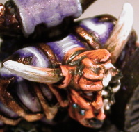 The exposed skull and horns on the model's face